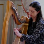 Emma Benson playing the harp