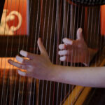 Hands playing the harp